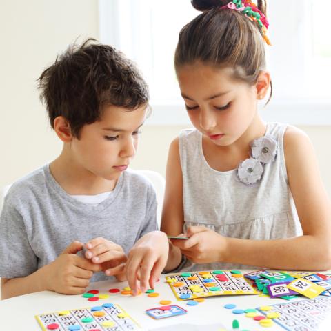 Two kids playing bingo
